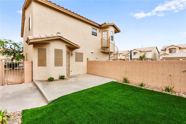 7566 Glowing Ember Ct Unit 101, Las Vegas, NV 89130 - rear view of house with stucco siding, a tile roof, a patio area, and a residential view