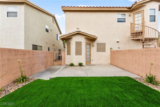 7566 Glowing Ember Ct Unit 101, Las Vegas, NV 89130 - rear view of property with stucco siding, a patio, and a tile roof