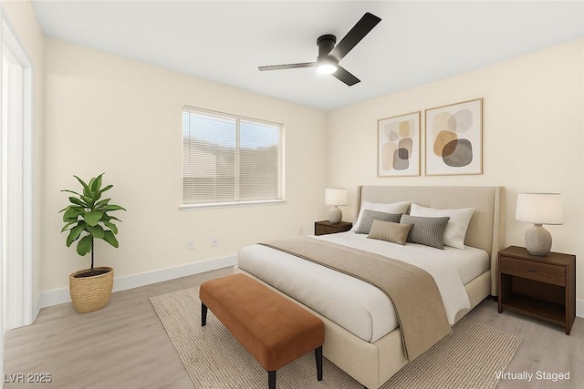 7566 Glowing Ember Ct Unit 101, Las Vegas, NV 89130 - bedroom featuring light wood finished floors, baseboards, and a ceiling fan