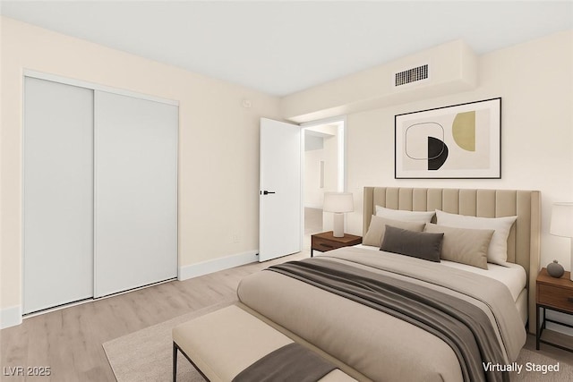 7566 Glowing Ember Ct Unit 101, Las Vegas, NV 89130 - bedroom featuring wood finished floors, a closet, and baseboards