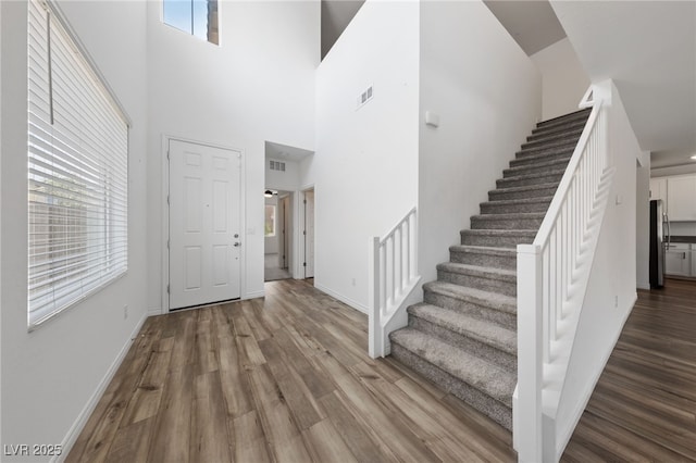9839 Berkley Brook Ct, Las Vegas, NV 89141 - foyer with stairway, wood finished floors, baseboards, and a towering ceiling