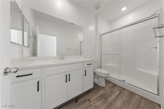 9839 Berkley Brook Ct, Las Vegas, NV 89141 - bathroom with a stall shower, toilet, vanity, and wood finished floors