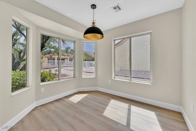 8513 Festival Dr, Las Vegas, NV 89134 - unfurnished dining area with wood finished floors and baseboards