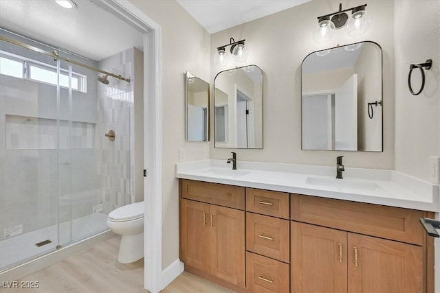 8513 Festival Dr, Las Vegas, NV 89134 - full bathroom with toilet, a stall shower, double vanity, and wood finished floors