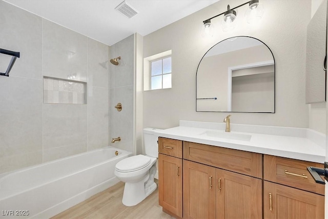 8513 Festival Dr, Las Vegas, NV 89134 - bathroom featuring toilet, vanity, bathtub / shower combination, and wood finished floors