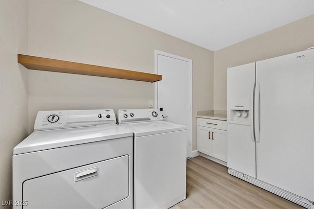 8513 Festival Dr, Las Vegas, NV 89134 - washroom with washing machine and dryer, light wood-style flooring, and cabinet space
