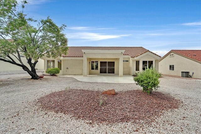 8513 Festival Dr, Las Vegas, NV 89134 - back of property with a tile roof, a patio, stucco siding, and central air condition unit
