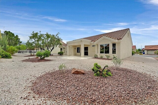 8513 Festival Dr, Las Vegas, NV 89134 - rear view of property featuring a tiled roof, a patio area, and stucco siding