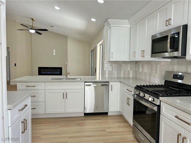 8513 Festival Dr, Las Vegas, NV 89134 - kitchen featuring stainless steel appliances, a sink, vaulted ceiling, recessed lighting, and ceiling fan