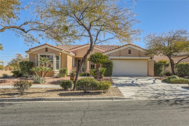 4750 Fiore Bella Blvd, Las Vegas, NV 89135 - view of front of house featuring stucco siding, an attached garage, driveway, and a tiled roof