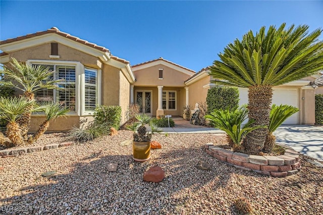 4750 Fiore Bella Blvd, Las Vegas, NV 89135 - view of front of house featuring stucco siding, a garage, a tiled roof, and concrete driveway
