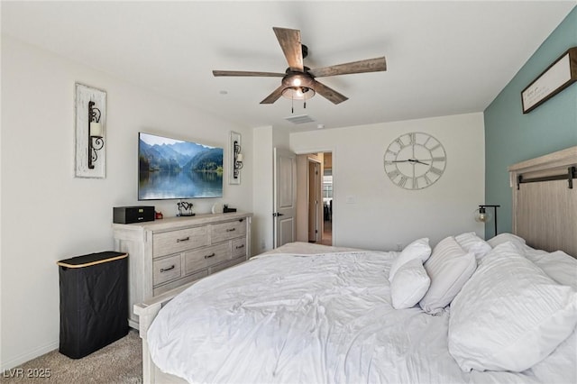 6807 Satin Silver Ct, North Las Vegas, NV 89086 - bedroom featuring light carpet, a barn door, a ceiling fan, and baseboards