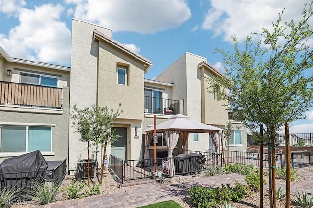 6807 Satin Silver Ct, North Las Vegas, NV 89086 - back of house featuring a gazebo, stucco siding, a patio area, and central AC unit
