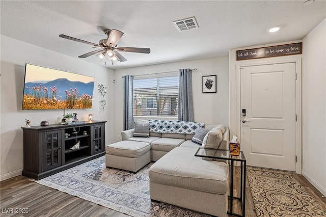 6807 Satin Silver Ct, North Las Vegas, NV 89086 - living room featuring wood finished floors, a ceiling fan, baseboards, and a textured ceiling