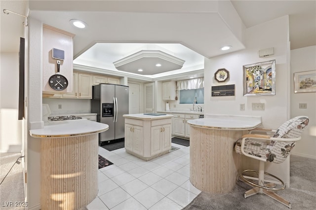 1060 Calico Ridge Dr, Henderson, NV 89011 - kitchen featuring stainless steel fridge, a peninsula, range, recessed lighting, and light countertops