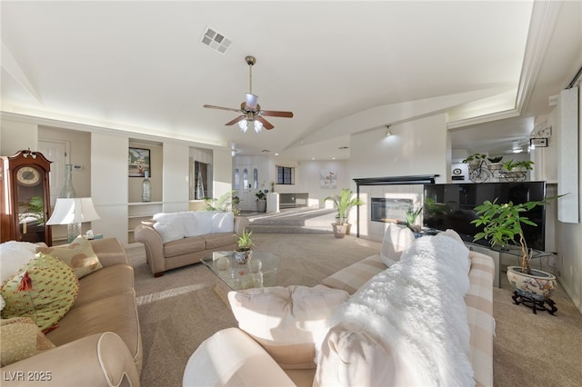 1060 Calico Ridge Dr, Henderson, NV 89011 - carpeted living room featuring ceiling fan, lofted ceiling, and a glass covered fireplace