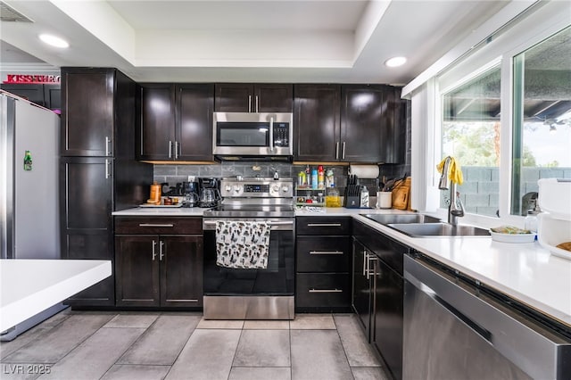 3400 Sioux Way, Las Vegas, NV 89169 - kitchen featuring stainless steel appliances, a sink, light countertops, tasteful backsplash, and recessed lighting