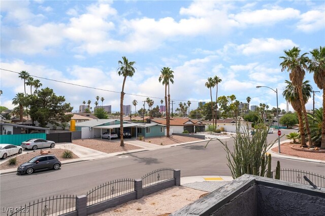 3400 Sioux Way, Las Vegas, NV 89169 - view of asphalt street featuring traffic signs, curbs, sidewalks, a residential view, and a gate