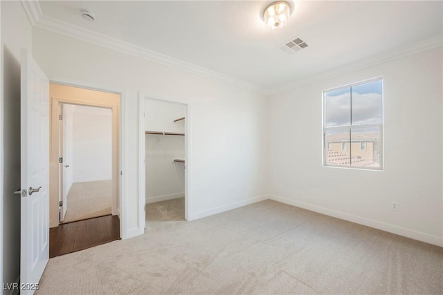 7466 Matilda St, Las Vegas, NV 89113 - unfurnished bedroom with carpet, crown molding, baseboards, and a walk in closet
