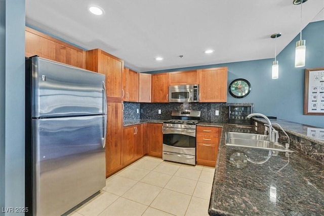 150 Las Vegas Blvd Unit 1004, Las Vegas, NV 89101 - kitchen featuring appliances with stainless steel finishes, a sink, decorative backsplash, brown cabinets, and light tile patterned flooring
