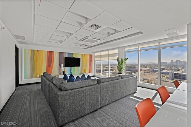 150 Las Vegas Blvd Unit 1004, Las Vegas, NV 89101 - living area featuring dark colored carpet, a raised ceiling, and floor to ceiling windows