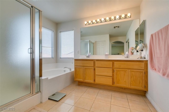 2418 Brockton Way, Henderson, NV 89074 - full bathroom with double vanity, a shower stall, tile patterned flooring, and a garden tub