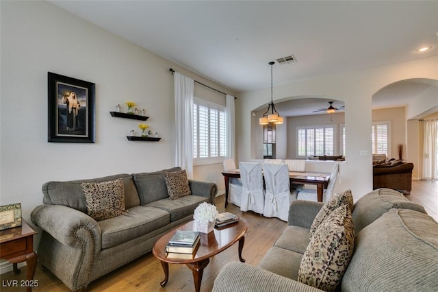 2418 Brockton Way, Henderson, NV 89074 - living area featuring arched walkways, wood finished floors, and a ceiling fan