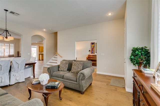 2418 Brockton Way, Henderson, NV 89074 - living area featuring arched walkways, light wood-style floors, stairs, and recessed lighting