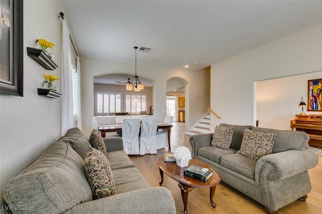 2418 Brockton Way, Henderson, NV 89074 - living room with arched walkways, light wood-type flooring, stairs, and recessed lighting