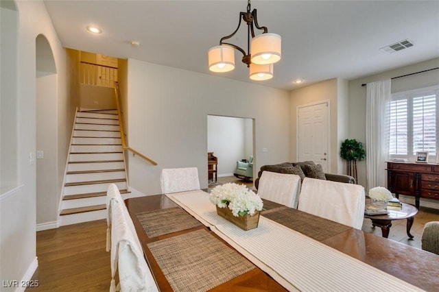 2418 Brockton Way, Henderson, NV 89074 - dining room featuring stairs, wood finished floors, a chandelier, recessed lighting, and arched walkways
