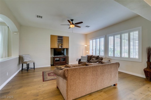 2418 Brockton Way, Henderson, NV 89074 - living room with a ceiling fan, arched walkways, and light wood-style floors