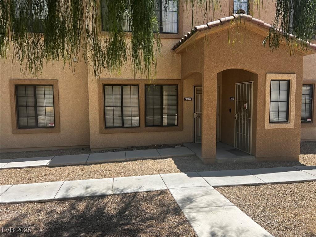 2041 Hussium Hills St Unit 104, Las Vegas, NV 89108 - view of exterior entry featuring stucco siding