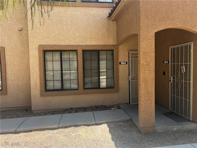 2041 Hussium Hills St Unit 104, Las Vegas, NV 89108 - doorway to property featuring stucco siding