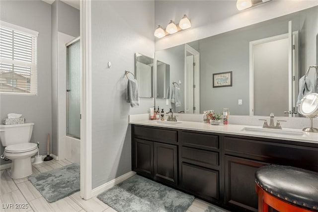 5616 Silver Cascade Ave, Las Vegas, NV 89131 - bathroom with double vanity, toilet, combined bath / shower with glass door, and baseboards