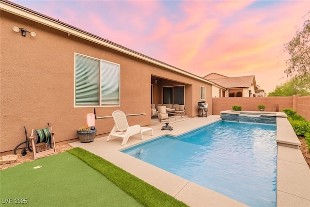 5616 Silver Cascade Ave, Las Vegas, NV 89131 - pool at dusk featuring an area to practice putting, a patio, a fenced backyard, and an in-ground hot tub