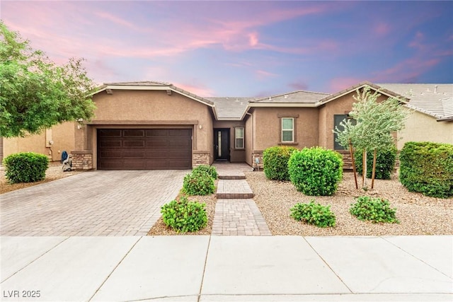 5616 Silver Cascade Ave, Las Vegas, NV 89131 - ranch-style home featuring stucco siding, decorative driveway, a garage, stone siding, and a tile roof