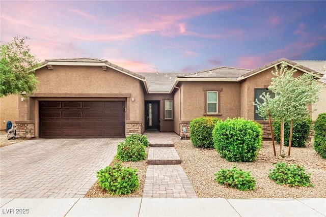 5616 Silver Cascade Ave, Las Vegas, NV 89131 - single story home with stucco siding, a garage, decorative driveway, a tiled roof, and stone siding