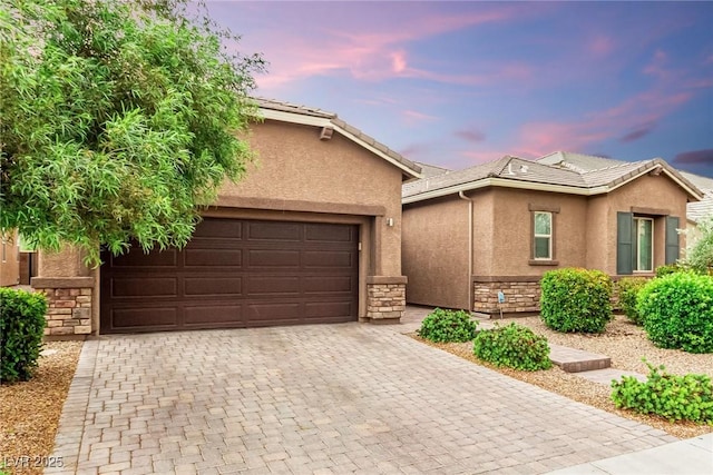 5616 Silver Cascade Ave, Las Vegas, NV 89131 - view of front of property with stone siding, stucco siding, and decorative driveway