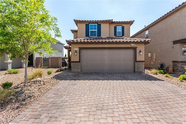 9690 Langden Brook St, Las Vegas, NV 89178 - mediterranean / spanish-style house featuring stucco siding, decorative driveway, an attached garage, and a tile roof
