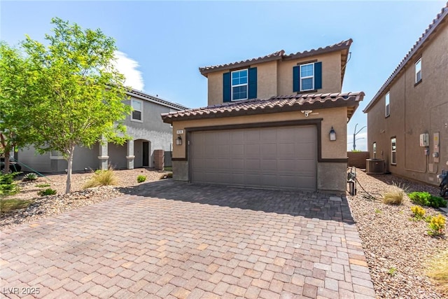 9690 Langden Brook St, Las Vegas, NV 89178 - mediterranean / spanish-style house with stucco siding, decorative driveway, a tile roof, and an attached garage
