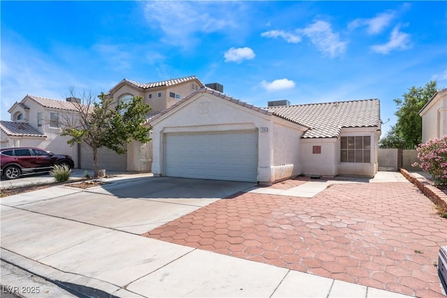 1740 Leaning Pine Way, Las Vegas, NV 89128 - mediterranean / spanish house featuring concrete driveway, a tile roof, stucco siding, and a garage