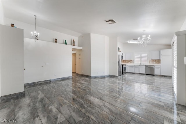 1740 Leaning Pine Way, Las Vegas, NV 89128 - unfurnished living room featuring a chandelier, marble finish flooring, baseboards, and a sink