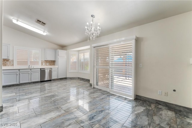 1740 Leaning Pine Way, Las Vegas, NV 89128 - unfurnished dining area featuring vaulted ceiling, a chandelier, light marble finish floors, and a sink