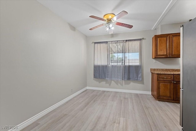 808 Reynolds Ave, North Las Vegas, NV 89030 - unfurnished dining area featuring light wood-style flooring, a ceiling fan, and baseboards