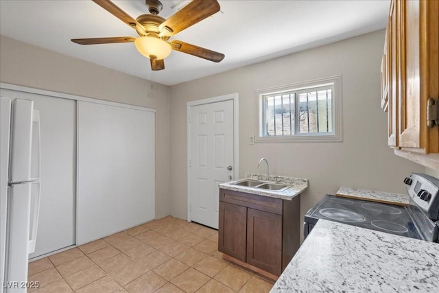 808 Reynolds Ave, North Las Vegas, NV 89030 - laundry room featuring a sink, light tile patterned flooring, and a ceiling fan