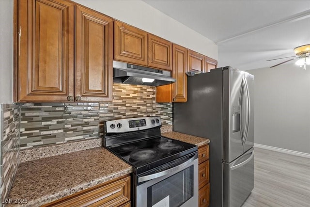 808 Reynolds Ave, North Las Vegas, NV 89030 - kitchen featuring appliances with stainless steel finishes, under cabinet range hood, and brown cabinets