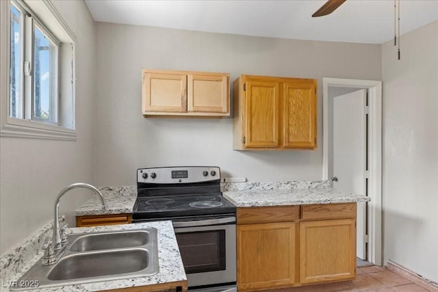 808 Reynolds Ave, North Las Vegas, NV 89030 - kitchen with electric range, a sink, ceiling fan, light tile patterned flooring, and light brown cabinetry