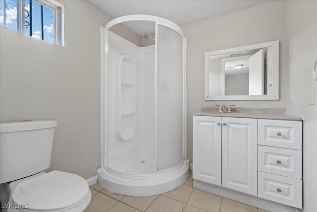 808 Reynolds Ave, North Las Vegas, NV 89030 - full bathroom with a stall shower, toilet, vanity, and tile patterned flooring