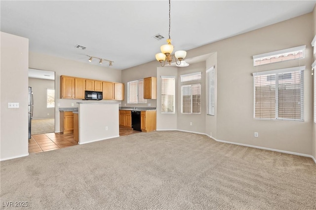 5307 Wild Orchid St, North Las Vegas, NV 89031 - kitchen with black appliances, light colored carpet, a chandelier, and healthy amount of natural light