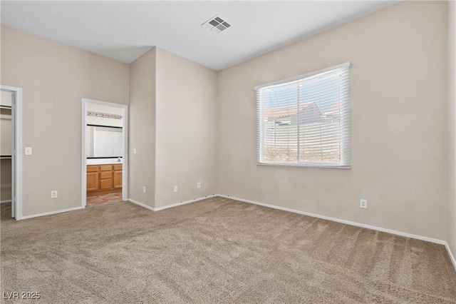 5307 Wild Orchid St, North Las Vegas, NV 89031 - unfurnished bedroom with carpet floors, a walk in closet, baseboards, connected bathroom, and a closet